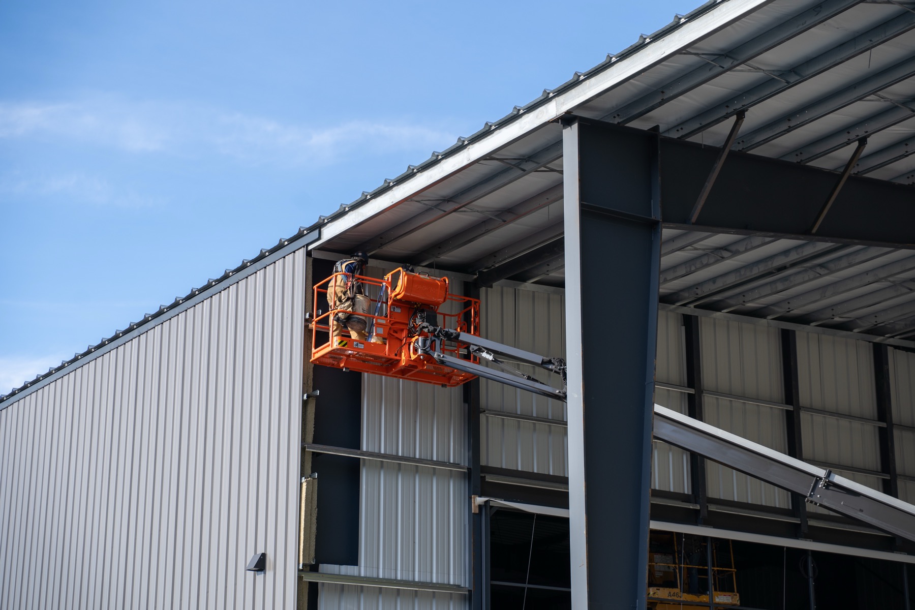 Industrial construction site with a boom lift on a steel structure